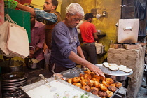 India, Uttar Pradesh, Varanasi, A food hotel serving idlis & dahl vada in the old city.