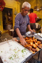 India, Uttar Pradesh, Varanasi, A food hotel serving idlis & dahl vada in the old city.