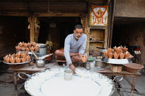 India, Uttar Pradesh, Allahabad, A vendor selling mishti doi sweet curd at a food hotel.