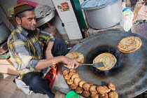 India, Uttar Pradesh, Faizabad, A muslim cook frying parathas.