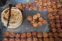India, Uttar Pradesh, Faizabad, Display of cooked parathas and mutton patties in a food hotel.