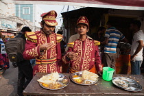 India, Uttar Pradesh, Lucknow, Musicians from a Band eat thali at a food hotel.