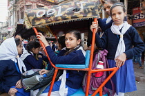 India, New Delhi, Schoogirls in a cycle rickshaw in Chandni Chowk in the old city of Delhi.