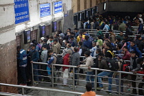 India, New Delhi, Passengers queue at the ticket office in Delhi Junction Railway Station.