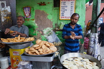 India, New Delhi, A cook making kachori at a street stall in the old city of Delhi.