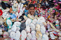 India, New Delhi, A shoe & sandal vendor in the cotton market in the old city of Delhi.