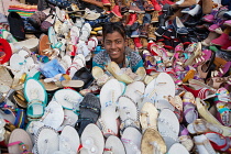 India, New Delhi, A shoe & sandal vendor in the cotton market in the old city of Delhi.