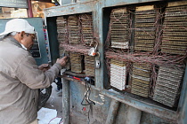 India, New Delhi, An electrician working on a fuse box in Chandni Chowk in the old city of Delhi.