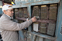 India, New Delhi, An electrician working on a fuse box in Chandni Chowk in the old city of Delhi.