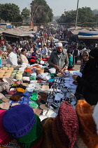 India, New Delhi, Vendor selling muslim headwear in the cotton market in the old city of Delhi.