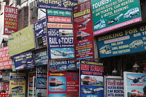 India, New Delhi, Advetisement boards and hoardings for travel services in the Paharganj district of Delhi.