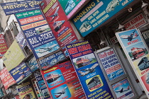 India, New Delhi, Advetisement boards and hoardings for travel services in the Paharganj district of Delhi.