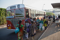 India, Mumbai, Passengers board a bus outside Chhatrapati Shivaji International Airport.