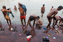 India, West Bengal, Kolkata, Men wash and bathe in the Hooghly River at Malik Ghat.