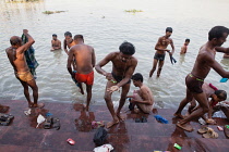 India, West Bengal, Kolkata, Men wash and bathe in the Hooghly River at Malik Ghat.