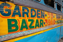 India, West Bengal, Kolkata, Public bus with its destination to Garden Bazaar painted in bright colours on its side panel.