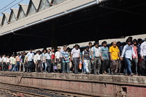 India, West Bengal, Kolkata, Commuters head for the exit at Howrah Railway Station.