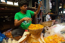 India, West Bengal, Kolkata, Vendor at Malik Ghat Flower Market.