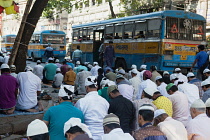 India, West Bengal, Kolkata, Muslim men at prayer on MG Road.