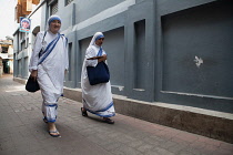 India, West Bengal, Kolkata, Missionaries of Charity sister in the street outside the Mother's House.