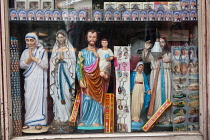 India, West Bengal, Kolkata, Window display of a shop in selling Christian icons and Mother Teresa souvenirs and memorabilia.