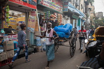 India, West Bengal, Kolkata, A rickshaw driver.