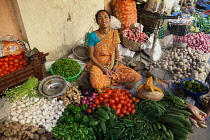 India, West Bengal, Kolkata, Vendor at the vegetable market in the Garia district.