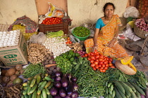 India, West Bengal, Kolkata, Vendor at the vegetable market in the Garia district.