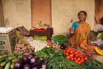 India, West Bengal, Kolkata, Vendor at the vegetable market in the Garia district.