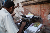 India, West Bengal, Kolkata, A street typist in prepares a document for a client.
