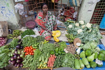 India, West Bengal, Kolkata, Vendor in the vegetable market in the Garia district.