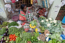 India, West Bengal, Kolkata, Vendor in the vegetable market in the Garia district.