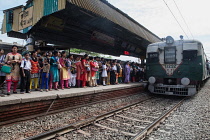 India, West Bengal, Kolkata, A train arrives at the platform at Garia Railway Station.