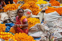 India, West Bengal, Kolkata, Vendor at Malik Ghat flower market.