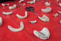 India, West Bengal, Asansol, Display of dentures and dental equipment by a street dentist.