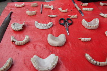 India, West Bengal, Asansol, Display of dentures and dental equipment by a street dentist.