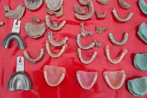 India, West Bengal, Asansol, Display of dentures and dental equipment by a street dentist.