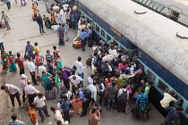 India, Bihar, Gaya, Passengers attempt to board an overcrowded second-class carriage of a train at Railway Station.