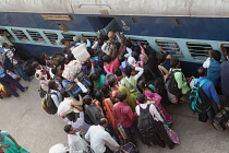 India, Bihar, Gaya, Passengers attempt to board an overcrowded second class carriage of a train at Railway Station.