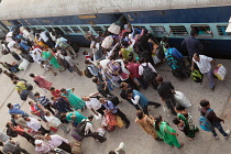 India, Bihar, Gaya, Passengers attempt to board an overcrowded second class carriage of a train at Railway Station.