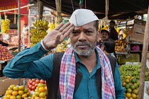 India, Bihar, Gaya, Portrait of a Hindu man in a Nehru cap giving a salute.