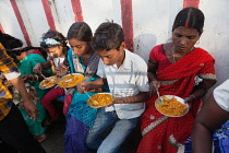 India, Bihar, Bodhgaya, A family eating vegetarian street food in Bodh.