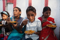 India, Bihar, Bodhgaya, A family eating vegetarian street food in Bodh.