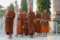 India, Bihar, Bodhgaya, Buddhist monks pray as they perambulate the Giant Buddha Statue at Bodh.