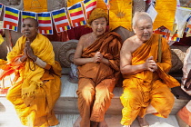 India, Bihar, Bodhgaya, Pilgrims pray at the Mahabodhi Temple at Bodh.