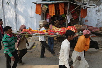 India, Bihar, Gaya, A body is carried through the streets of to the cremation site on the ghats of the Phalgu River.