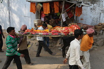 India, Bihar, Gaya, A body is carried through the streets of to the cremation site on the ghats of the Phalgu River.