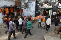India, Bihar, Gaya, A body is carried through the streets of to the cremation site on the ghats of the Phalgu River.
