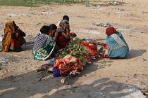 India, Bihar, Gaya, A bereaved family grieve over the body of a deceased relative before its cremation.