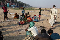 India, Bihar, Gaya, A bereaved family grieve over the body of a deceased relative before its cremation.